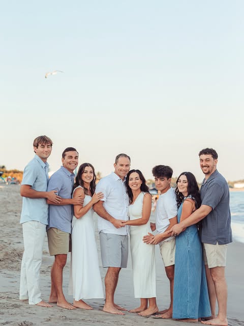 Family beach portrait in soft blue and white
