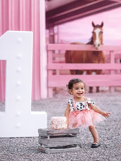 A child celebrating a birthday in pink